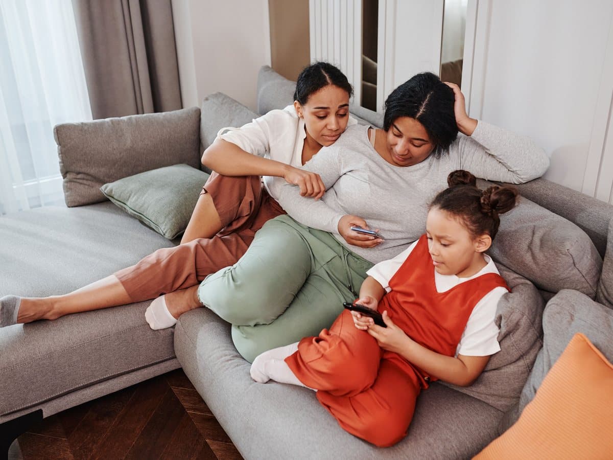 A family relaxing together on a couch at home